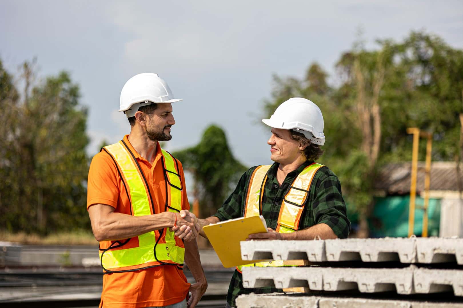 Professional handshake between general contractor and subcontractor sealing a trusted agreement